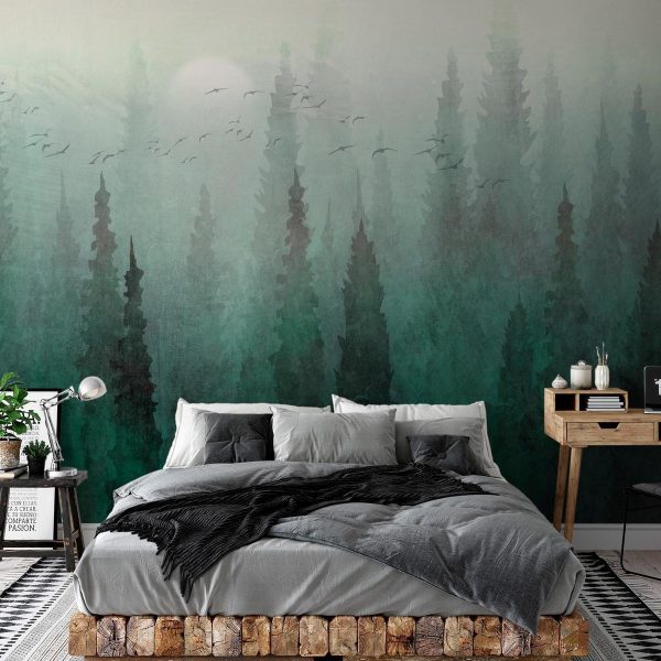 Wall Mural - Bird's eye perspective - landscape of a green forest with trees in the mist