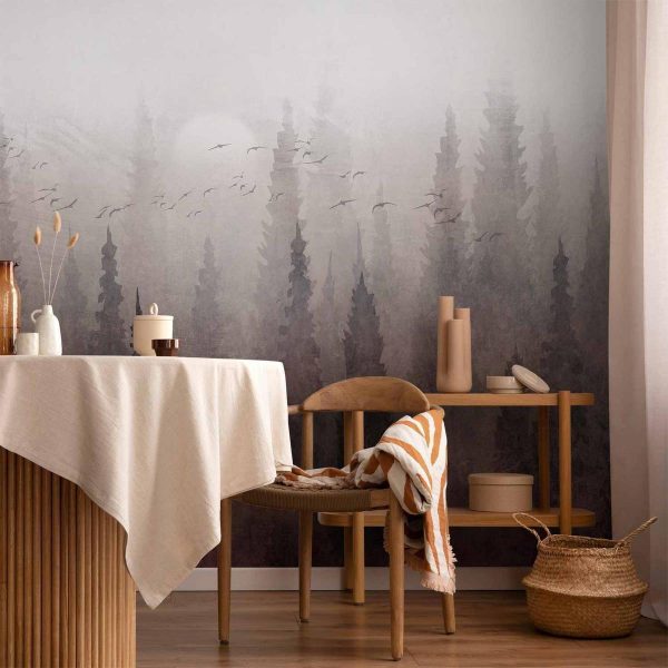 Wall Mural - Bird's flight over treetops - landscape of a dark forest in fog