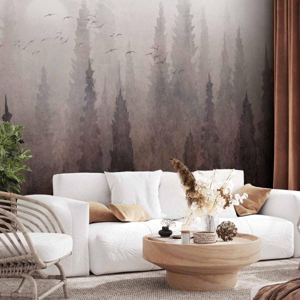 Wall Mural - Bird's flight over treetops - landscape of a dark forest in fog